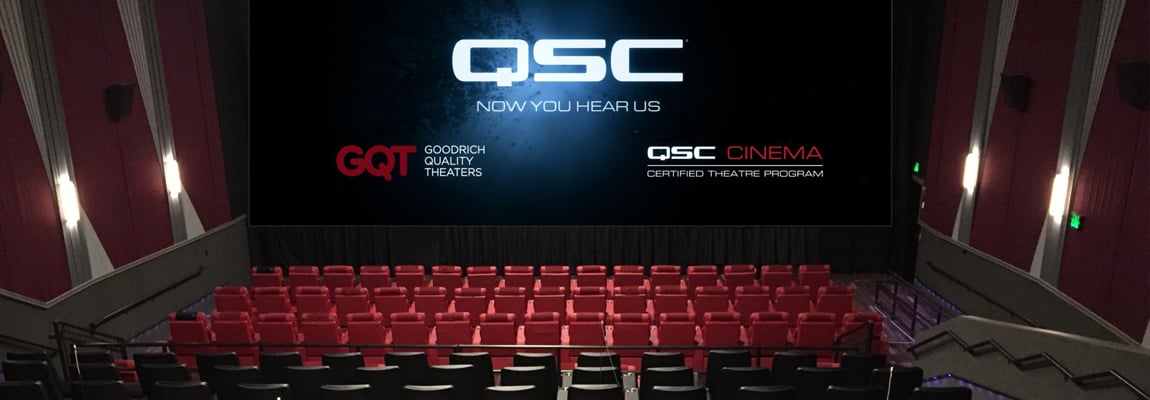 a Cinema inside the Kendall 11 GDX complex displaying the QSC logo on the large screen