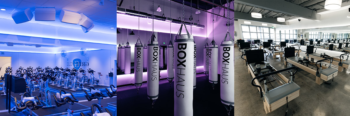 Three views inside the Boutique Fitness Studios featuring exercising bikes, punching bags, and rowing machines