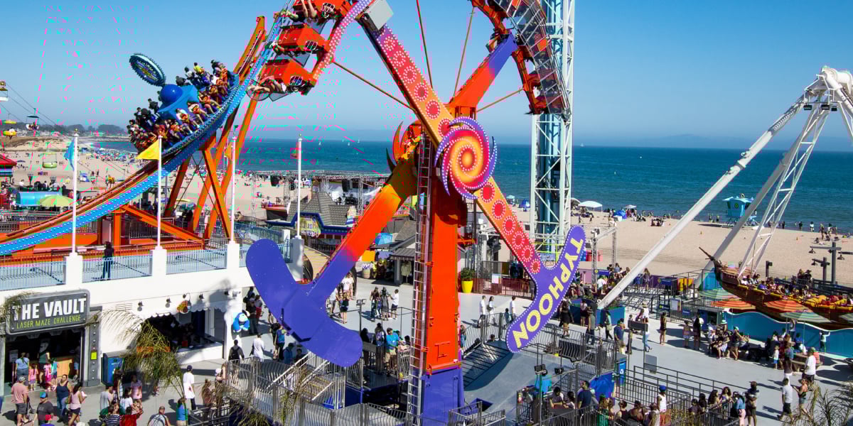 Santa Cruz Beach Boardwalk with an amusement rude in the foreground, and the beach on the background