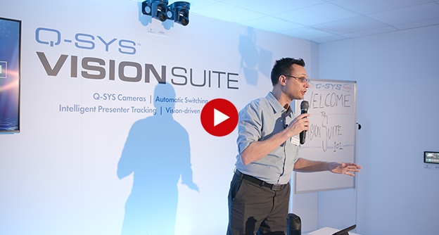 Video thumbnail of a man giving a presentation in a Q-SYS VisionSuite Room
