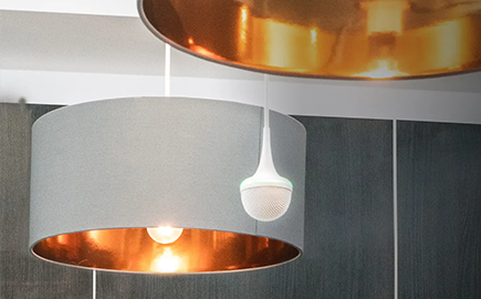 View of a ES954 hanging microphone array hanging next to a ceiling lamp