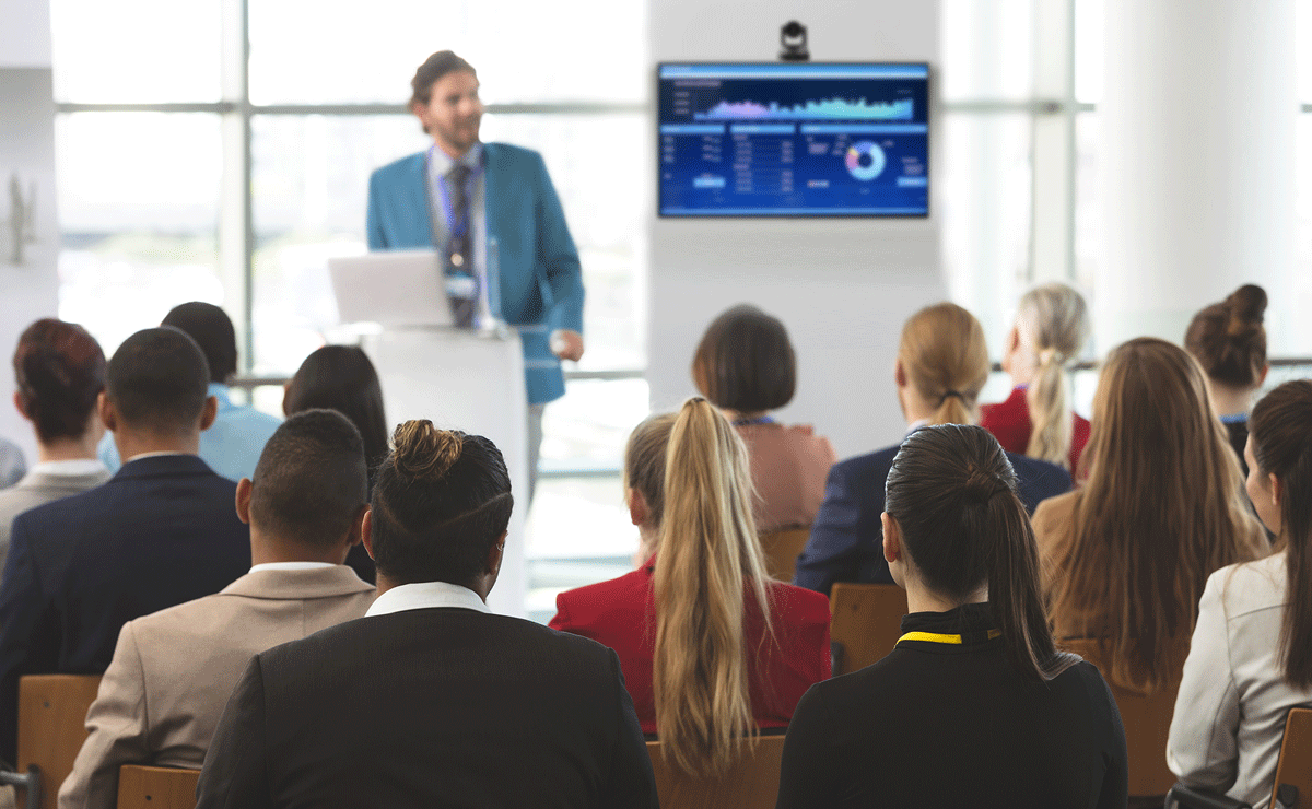 Image of a man speaking to a room of people