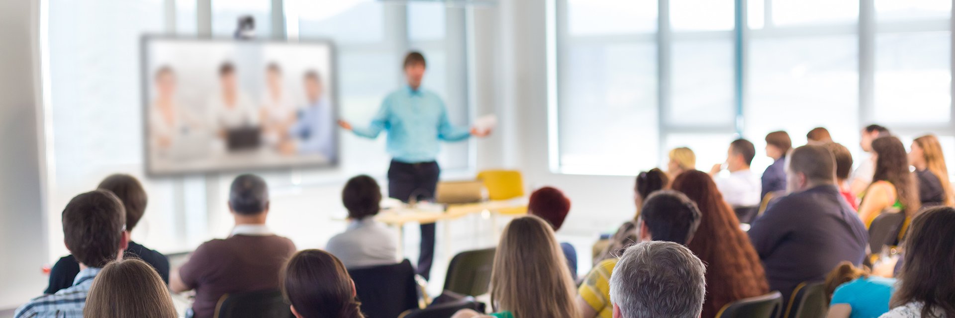 Image of presenter speaking to people in classroom