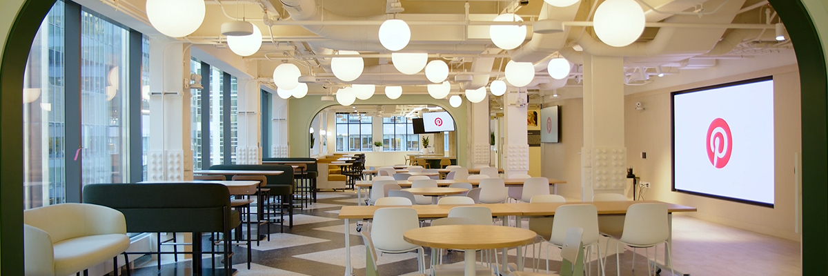 View of inside Pinterest corporate offices with various tables and screens