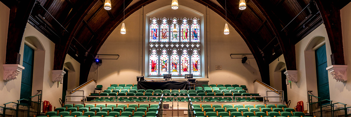 Stained class and the back of a lecture hall at Epsom College